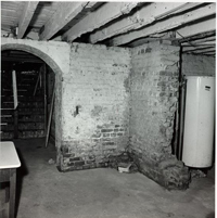 Black and White Photograph of Basement Showing Water Heater