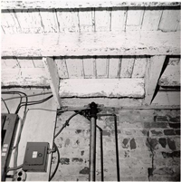 Black and White Photograph of Basement Ceiling showing Breaker Box