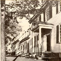 Black and white photo down row of houses