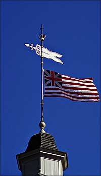 The Union Flag ripples defiance on the cupola.
