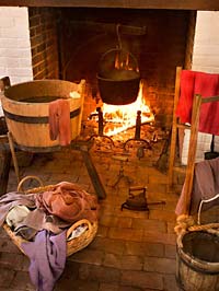 A freestanding laundry building, with water bucket, tub of hot water, drying rack, and iron, was an eighteenth-century development.