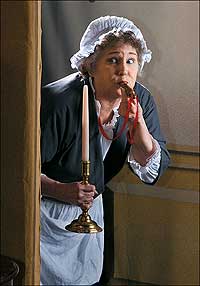 Stage manager Mamie Ruth Hitchens Blanton blows a whistle signaling a scene change.