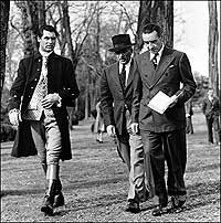 Cary Grant and studio executives stride toward the set of 1940's The Howards of Virginia.