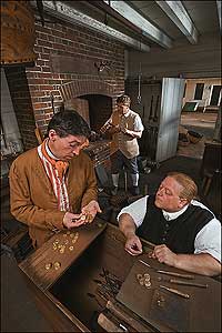 Minting money: Sowell, as counterfeiter Jackson, with Colonial Williamsburg journeyman blacksmiths Mike Noftsger and Roger Hohensee at the forge.