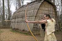 An interpreter shows his skill with bow and arrow