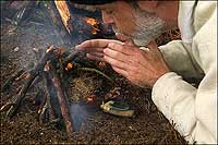 D. A. Saguto, portraying a
seventeenth-century settler, coaxes the flame he started with a burning lens