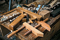 Able to make many of his tools, the carpenter used planes and clamps in woodworking.