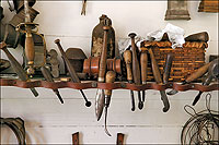 At the foundry, the smith finished a casting on the lathe with tools from this rack.