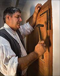 Colonial Williamsburg master carpenter Garland Wood attaches an HL hinge, designed for strength and not for piety.