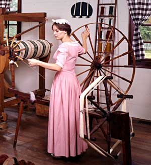Interpreter Beverly Henry spins at a “muckle,” or walking wheel, at right, the term being something of an all-purpose word for large.