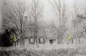 In the backyard of Williamsburg’s restored Tayloe House, above, stand two wooden outhouses—one partially obscured by trees—as dimly seen in the nineteenth-century photo below.