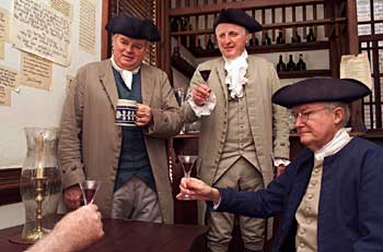 Interpreters Clayton Williams, William Webb, and Bob Brown, left to right, lift a glass in a Raleigh Tavern toast.