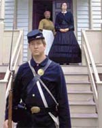 Mrs. C.B.T. Coleman, portrayed by Anne Marie Millar, and her servant, portrayed by Sandra Johnson, discover a Union sentry at the gate of Williamsburg's St. George Tucker House during a re-enactment