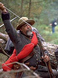 A Confederate reenactor loads his musket.
