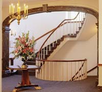A staircase curves through a carved-wood arch in the Inn.