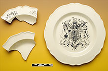 Fragments of a plate next to a whole plate.