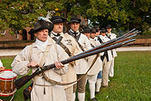 Soldiers holding rifles and standing in a line.