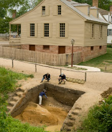 Archaeologists work in the ravine.