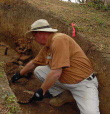 An archaeologist digs at the Secretary's Office.